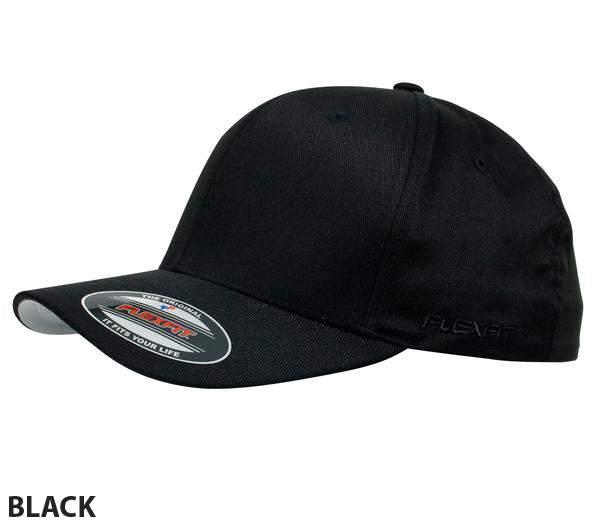 The FlexFit Worn By The World Cap is a stylish and comfortable black baseball cap with a slightly curved brim. It features a sticker on the brim displaying the Flexfit logo and product information, and the word "BLACK" is written at the bottom left corner of the image.