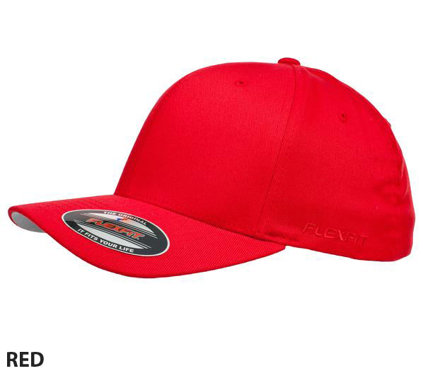A stylish and comfortable bright red Flexfit Worn By The World Cap with a curved brim and a sticker on the front of the bill. The cap is plain with no visible logos or designs. The text "RED" is written at the bottom left corner of the image.
