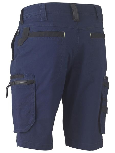 Revised Sentence: Rear view of the Bisley Flex & Move Stretch Utility Cargo Short in navy blue, showcasing reinforced belt loops, zippered pockets, and velcro straps on the sides. These comfortable shorts feature multiple pockets, including cargo pockets as well as flap and zipper pockets on the thighs.