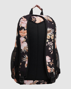 The Billabong Shallows Shaka Backpack is a black laptop bag with padded adjustable straps, pink floral print, mesh back panel and side pockets, plus a top handle covered in the floral pattern.
