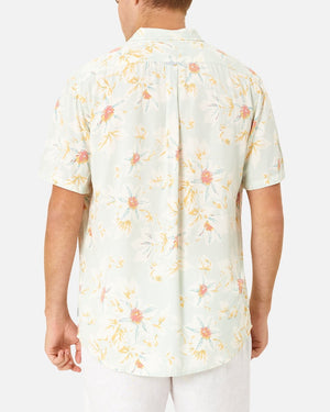 Wearing the Industrie The Esperanza Shirt, a comfortable classic fit made from 100% Rayon with pink and yellow flowers, a person stands with their back to the camera in light-colored pants against a plain white background.