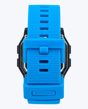 A close-up of the Rip Curl Atom Digital Watch’s blue textured strap and branded buckle, set against a plain white background.