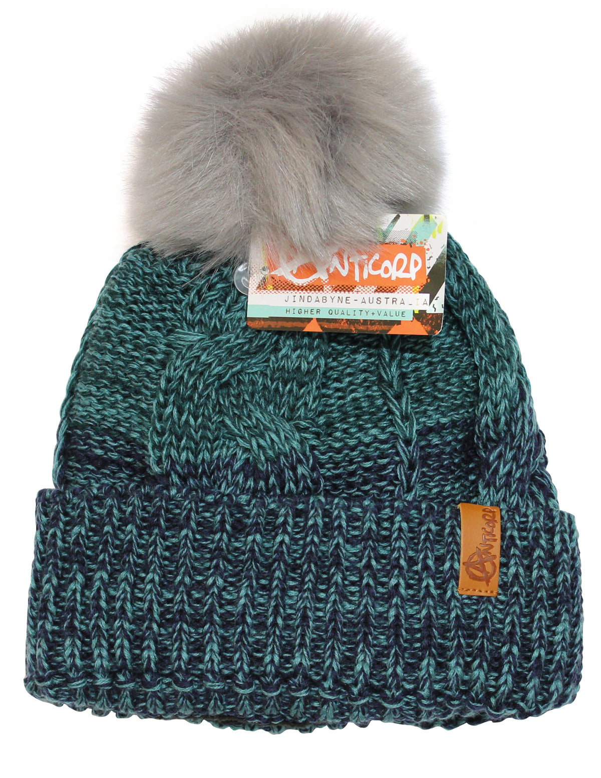 The Anticorp Ladies Freshies Beanie is a green and black knit hat with a large, fluffy gray pompom on top. It features a brown leather tag and an attached Anticorp label with information. Designed with a textured, braided pattern, it also includes a cozy fleece lining for extra warmth.