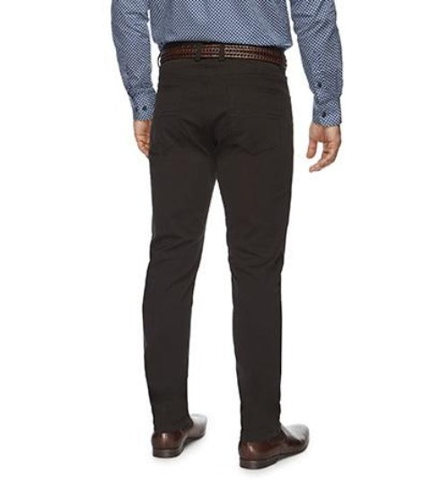 A person wearing a blue dress shirt, dark brown belt, and stylish City Club Austin Road Pants stands with their back facing the camera. They are also donning brown dress shoes. The background is plain white, enhancing the sharp City Club look.