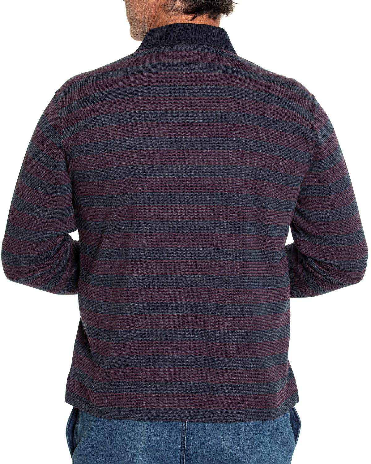 A person wearing the stylish Breakaway Lars Micro Prima Polo with ribbed cuffs and blue jeans is seen from the back. The individual has short hair and is standing with arms bent slightly, hands not visible.