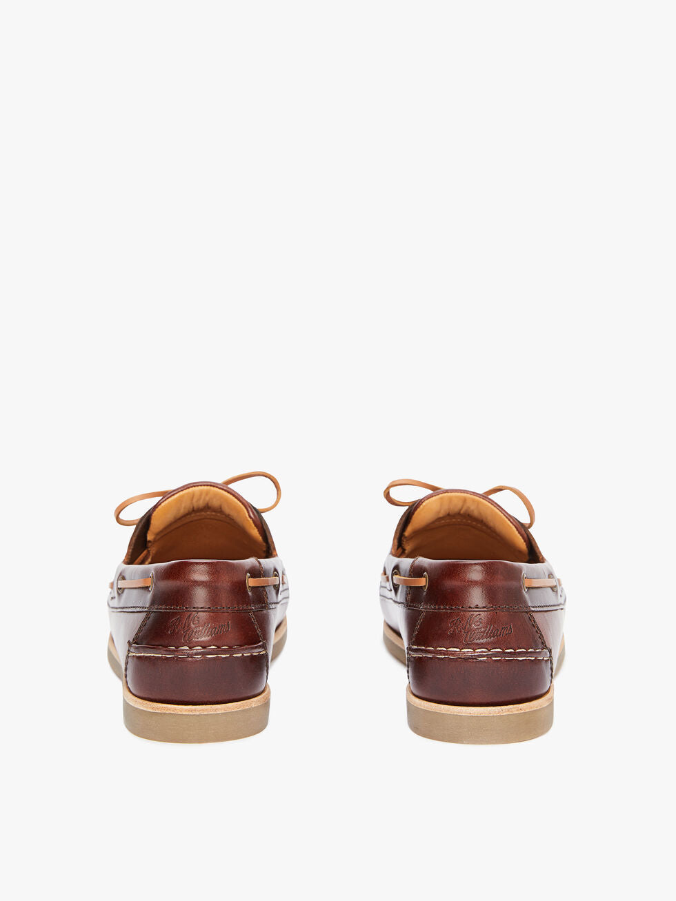 A rear view of the RM Williams Hobart Boat Shoe in brown yearling leather, showcasing tan laces, light tan rubber outsoles, stitching detail, and embossed branding on the heel.