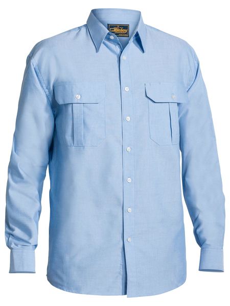 The Bisley Oxford Shirt Long Sleeve is a light blue, button-up shirt with two breast pockets, each secured by a buttoned flap. Crafted from a soft brushed cotton polyester blend, it offers generous sizing for optimum comfort and ease of movement. This shirt includes a collar and is fastened with white buttons down the front.