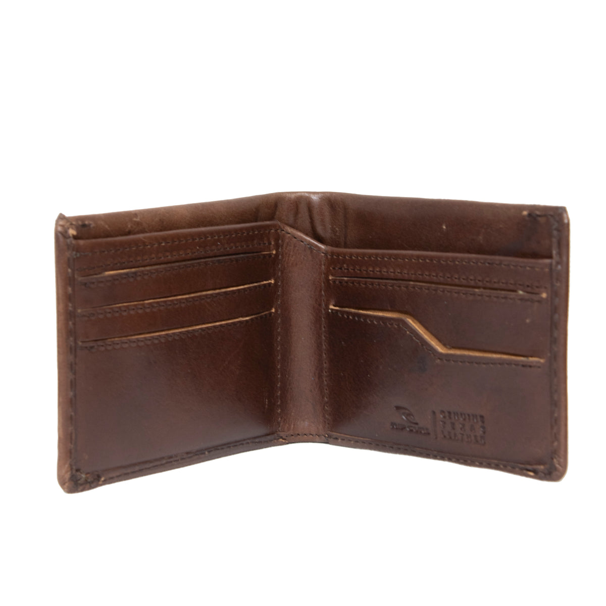 The Rip Curl Texas RFID All Day Wallet is open, showcasing its interior made of Genuine Texas Leather. There are multiple card slots on both sides, with a few showing slight wear. The empty wallet has a smooth, polished finish and features RFID protection with a small embossed logo on the right side.