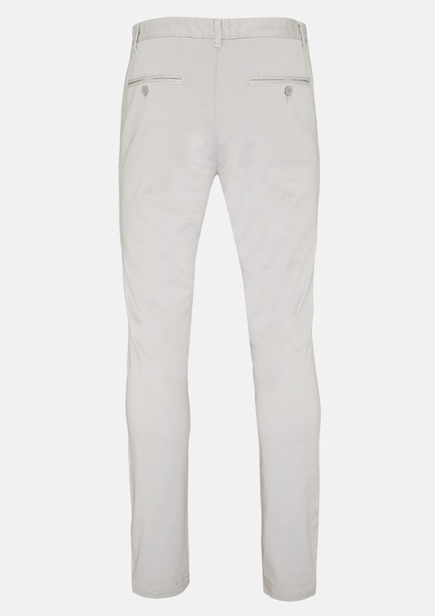 The Connor Platinum Slim Stretch Chino in gray features a tailored fit, belt loops, and two buttoned waist pockets. The smooth fabric has a subtle stretch and slight sheen, making it ideal for formal or business wear.