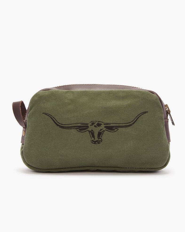 The RM Williams Ute Washbag is an olive green and brown canvas bag with leather trims, a black longhorn skull outline on the front, zipper closure, and side handle—showcasing classic RM Williams style.