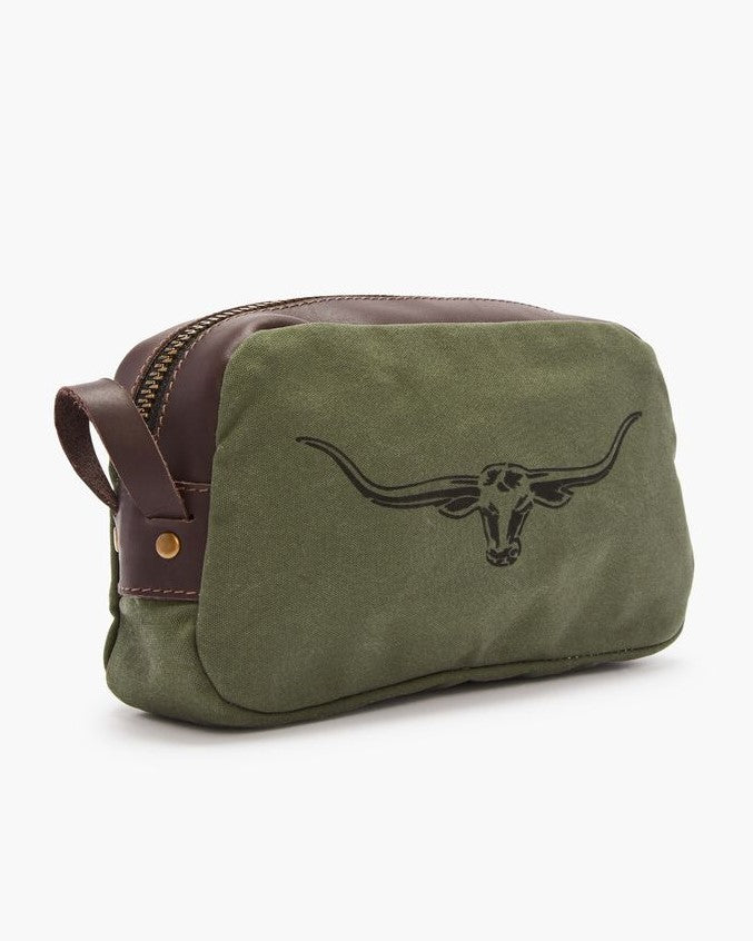The RM Williams Ute Washbag is a green canvas bag with brown leather trims, zipper closure, and a striking black longhorn skull graphic on the front.