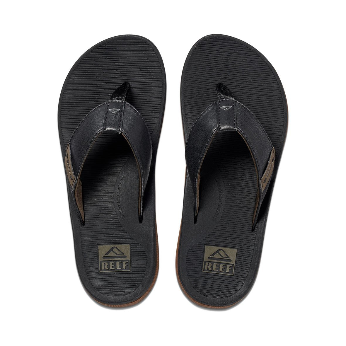 A pair of REEF Santa Ana flip-flops with a textured footbed and a dark brown strap. Featuring water-friendly materials and arch support, they offer optimal comfort. The Reef logo is visible on both the footbeds near the heel and on the straps. The comfortable thongs are placed side by side, with the toe sections pointing upward.