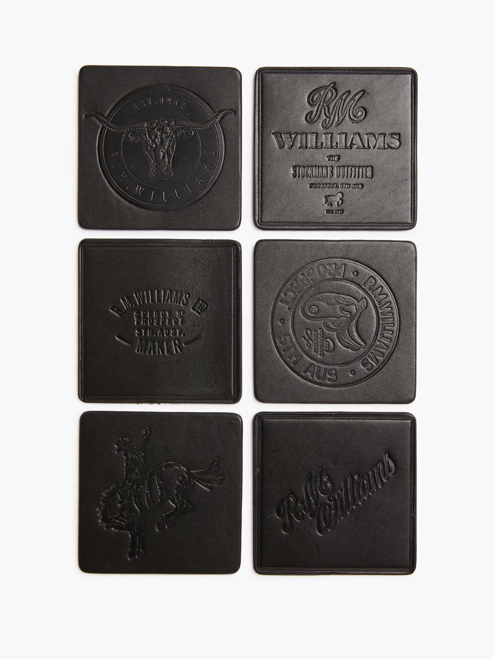 The RM Williams Heritage 6 Pack Coaster Set includes six square black leather coasters, each embossed with unique designs, logos, text, symbols, and images. Proudly Australian-made, they are arranged in two vertical rows of three.