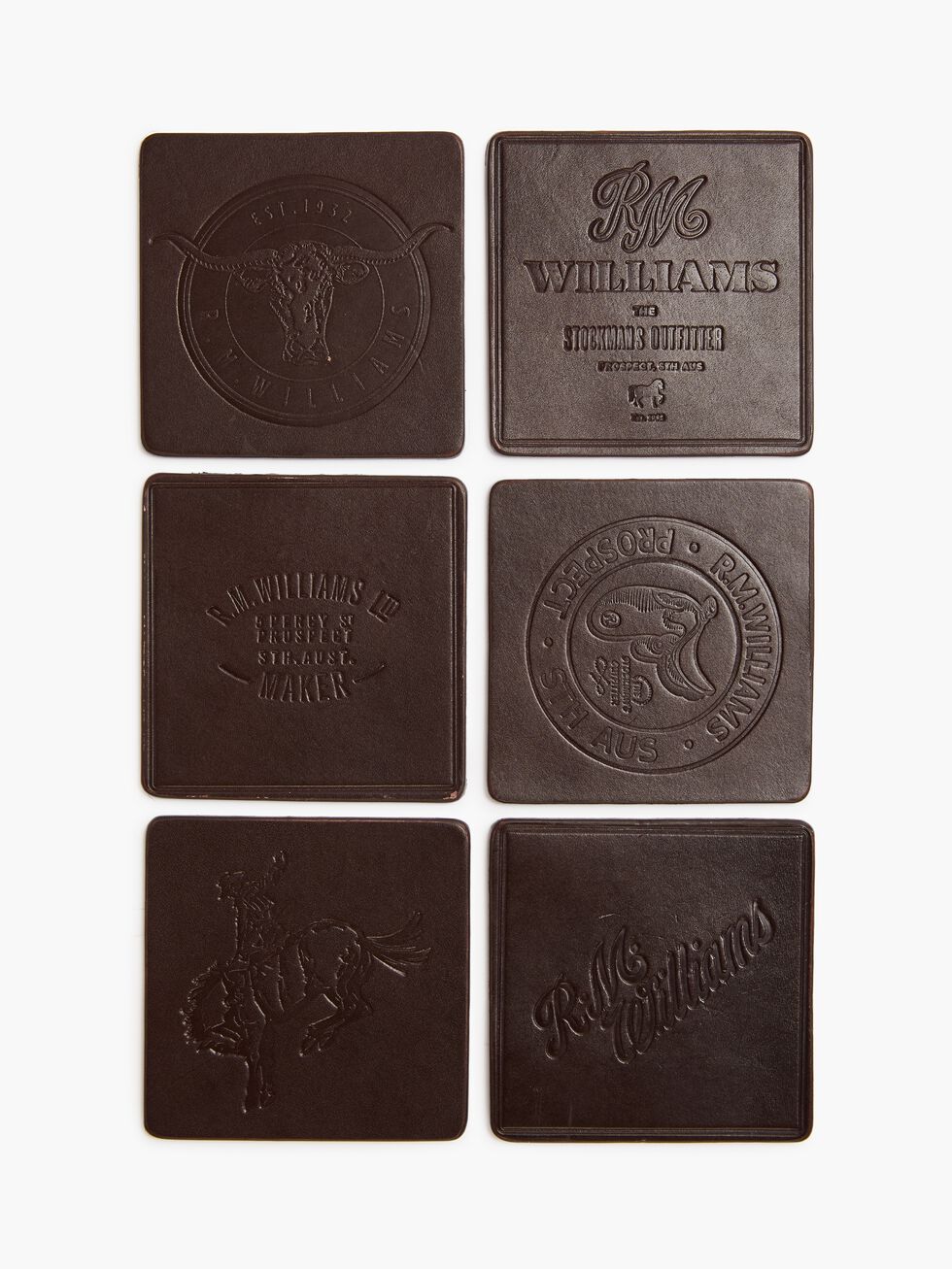 The RM Williams Heritage 6 Pack Coaster Set includes six brown leather coasters made in Australia, embossed with designs in two vertical columns featuring multiple RM Williams logos, circular motifs, and horse imagery.