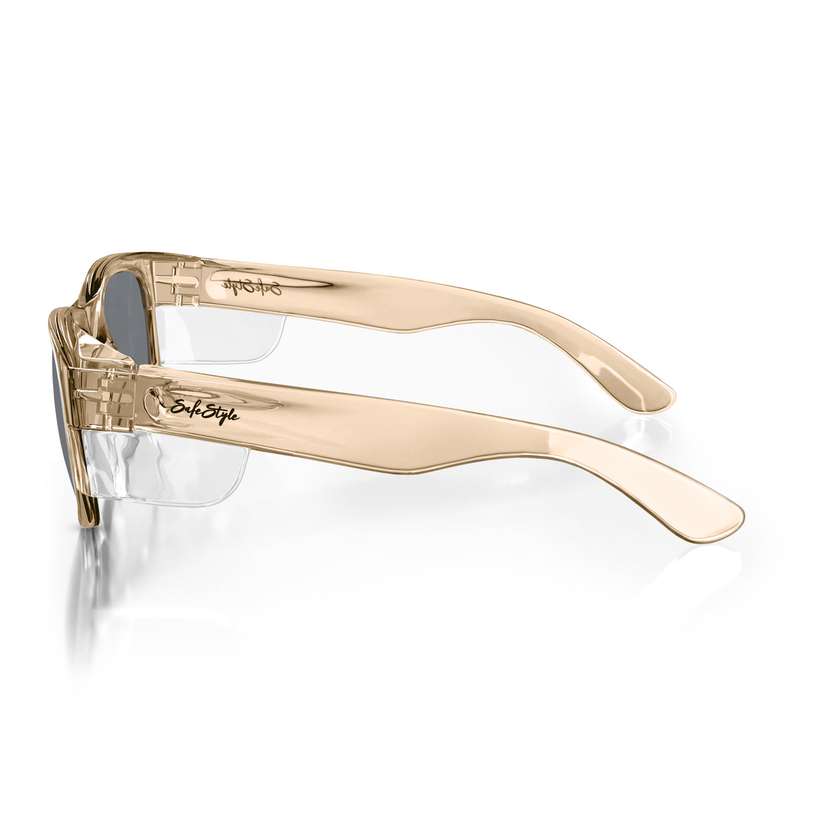 Side view of SafeStyle Classics with champagne frames and tinted lenses, featuring sleek, wide arms and a curved design. "SafeStyle" is printed on the polycarbonate frames as they rest on a white surface.