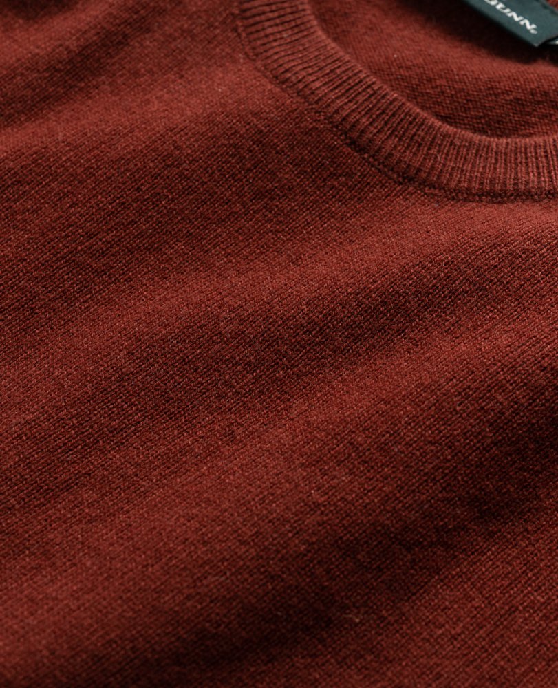 Close-up of the folded Rodd & Gunn Queenstown Sweater, featuring its ribbed collar and soft wool texture. The image emphasizes the warm, cozy look of this sweater—ideal for travel and layering.