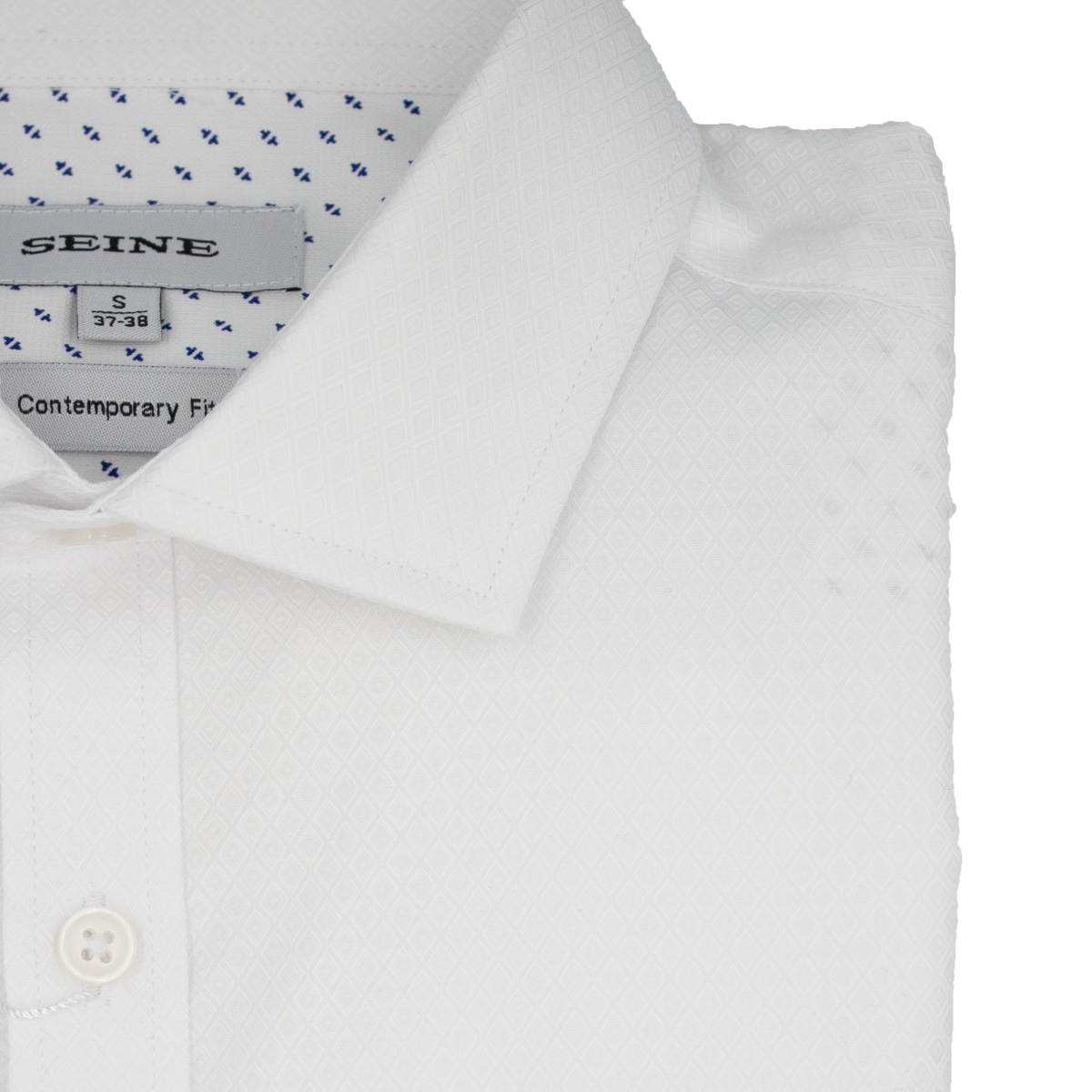 The folded Seine Dress Shirt is a white, contemporary fit with a subtle geometric diamond pattern and buttoned collar. It features small blue accents in the inner lining, a tag labeled "SEINE," and is marked as size small (37-38).
