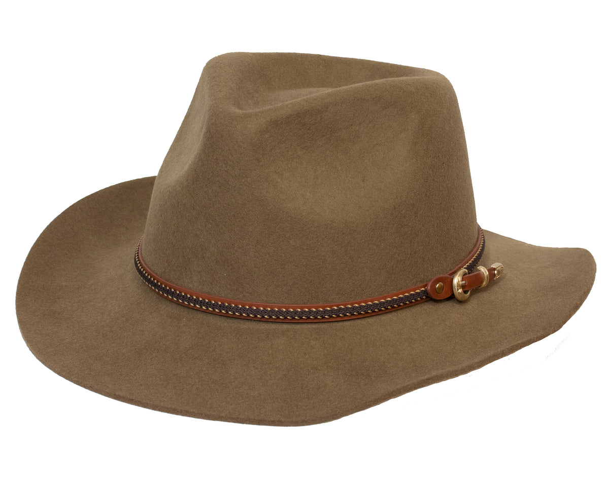 The Outback Nelson Wool Hat is a brown fedora crafted from Australian wool, featuring a slightly creased crown and a medium-width, downward-sloping brim. It includes a decorative woven band in brown, black, and beige wrapped around the base and secured with a small gold buckle on one side. This water-resistant hat also provides UPF protection.