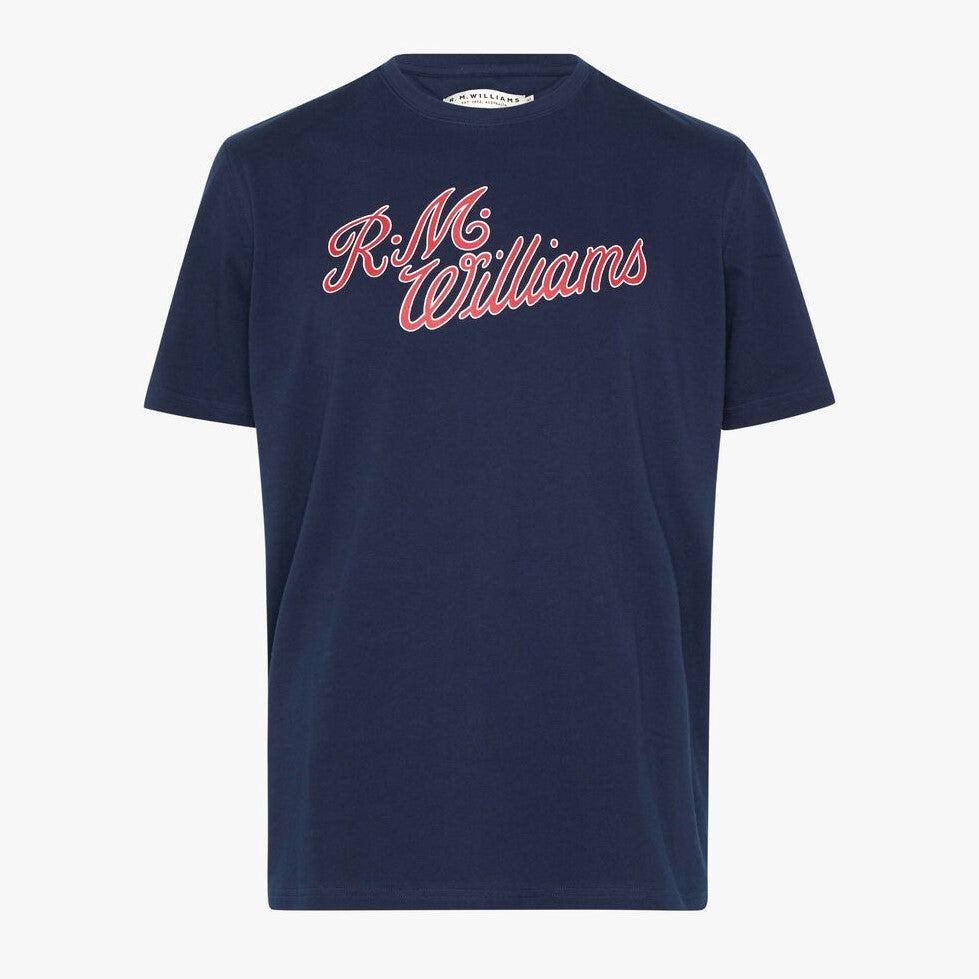 A navy blue RM Williams Script T-Shirt featuring "R.M. Williams" printed in red cursive lettering across the chest. Crafted from breathable cotton, this classic crew neck shirt with short sleeves is ideal for year-round wear, displayed against a plain white background.