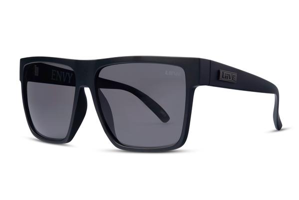 Liive Envy Sunglasses feature sleek black square frames with dark tinted polycarbonate lenses, offering lightweight construction. The "ENVY" branding graces a lens, while the temple arms bear the logo, ensuring both style and essential UV protection in sunny moments.