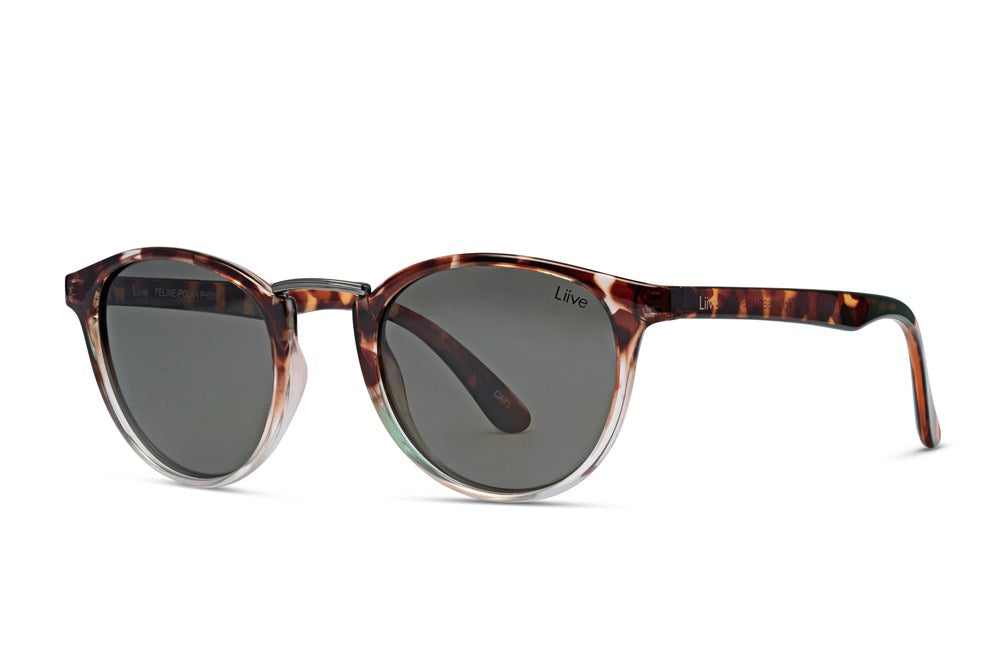 The Liive Feline Polar Sunglasses feature round frames with a marbled brown and black pattern, complemented by dark polarised grey lenses that provide UV protection. The brand name "Liive" is visible on the lens, accentuating their sleek and stylish design.