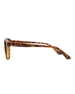 Side view of Liive Phoenix Polar Sunglasses featuring thin, brown tortoiseshell frames, grey polarized lenses for UV protection, slightly curved temples with a transparent section near the front, and a subtle brand name on the inner side.