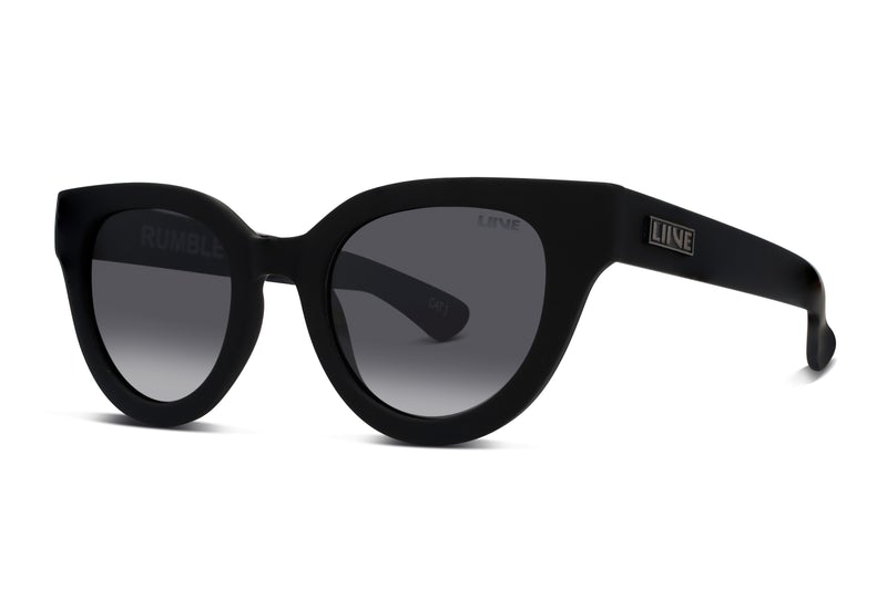 A pair of Liive Rumble Polar Sunglasses features round, dark-tinted, UV-protective polycarbonate lenses. The sunglasses are designed with thick, matte-finished black frames. The brand name "LiIVE" is displayed prominently on the temple hinge, while the model name "RUMBLE" is subtly etched onto one of the lenses.