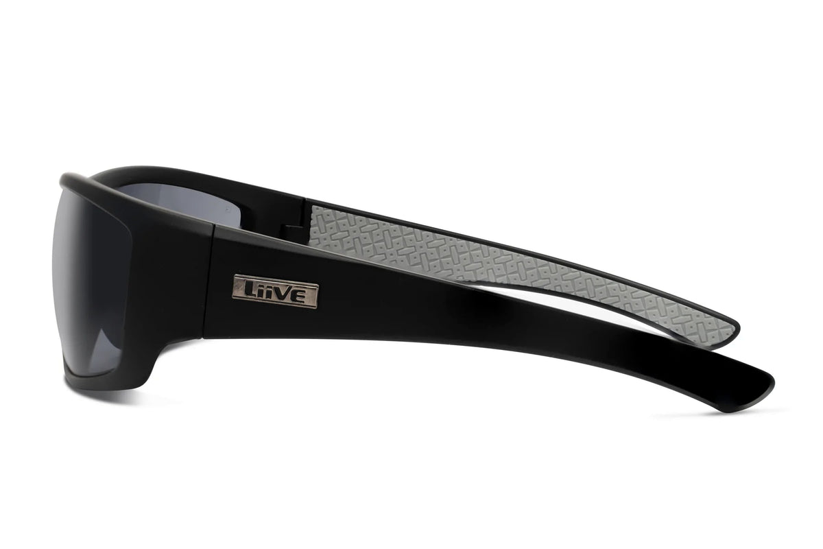 The Liive Z Hammer Safety Sunglasses are sleek black shades featuring UV protection, shatterproof lenses, and thick arms with a textured gray pattern inside. A small metal "Liive" logo enhances the style at the temples.