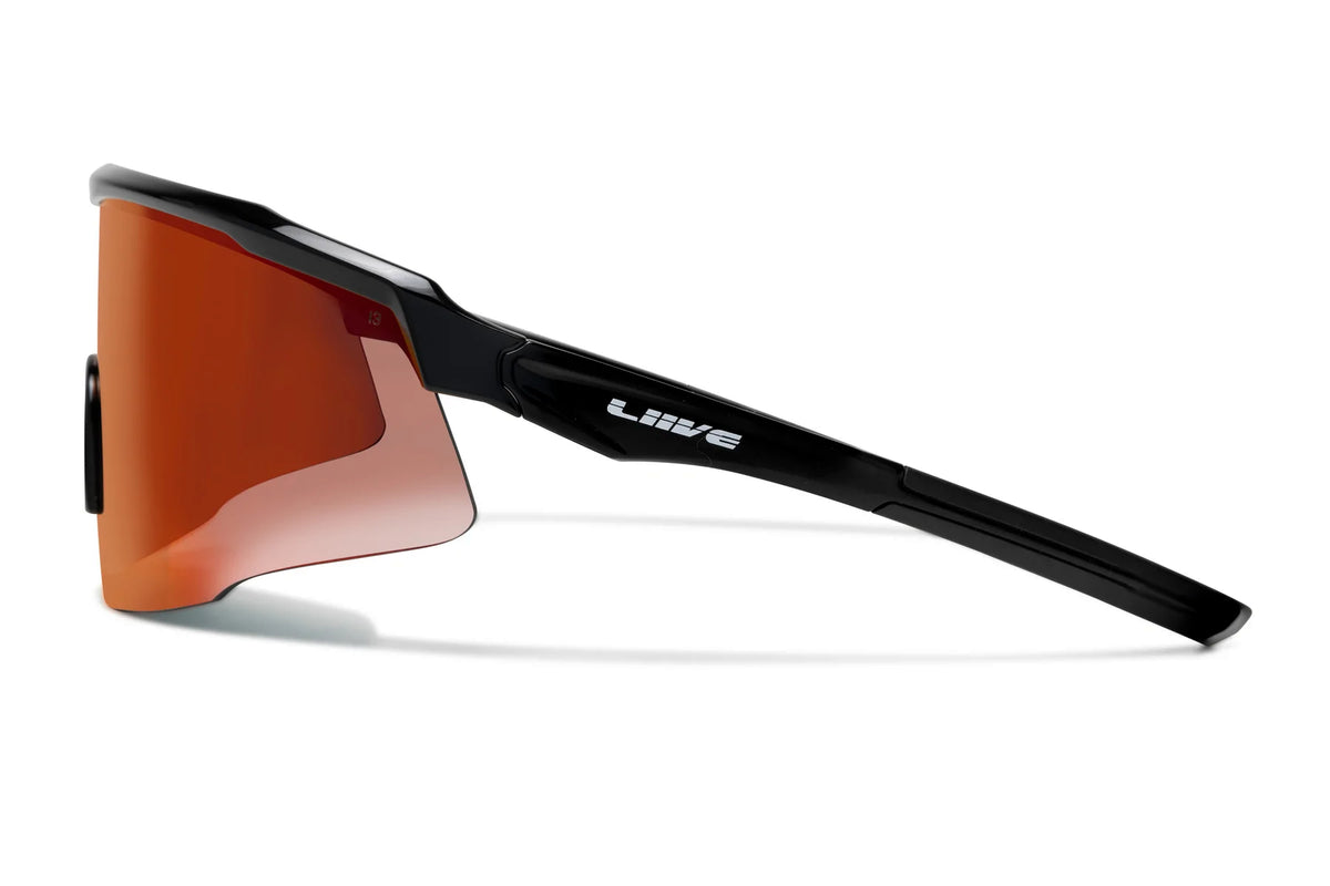 The Liive Z Chisel Safety Mirror Sunglasses feature orange-tinted, shatterproof lenses with UV protection and a sleek aerodynamic frame. The noticeable brand logo adorns the side, and the lenses curve slightly for improved peripheral coverage.