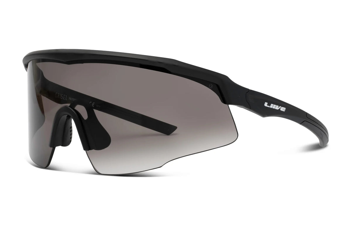 The Liive Z Chisel Safety Sunglasses boast a sleek, black frame with a single shatterproof lens and UV protection. "LIVE" is displayed on the side, and an adjustable nose piece ensures maximum comfort.