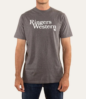 Sporting a casual gray "Ringers Western The Lodge Classic Fit T-Shirt" made from 100% cotton, with the iconic text and small cattle logo, a person effortlessly pairs it with dark blue jeans against a plain white background.