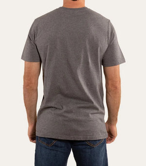 A man in a Ringers Western The Lodge Classic Fit T Shirt and blue jeans stands with his back to the camera against a light background. Made from 100% cotton, the tee offers comfort, while his arms hang relaxed by his sides.