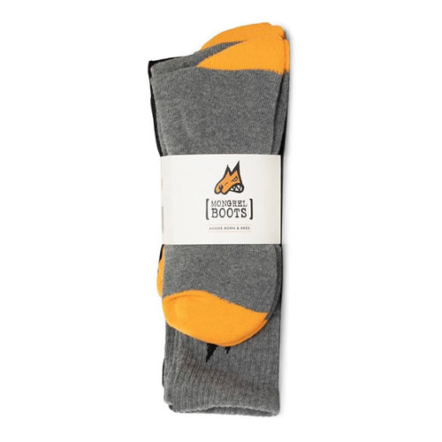 A folded pair of Mongrel 5 Pack Cotton Socks in gray cotton features yellow toe and heel accents. The socks, part of the set, are wrapped with a label displaying a fox logo and the brand name "Mongrel Boots.