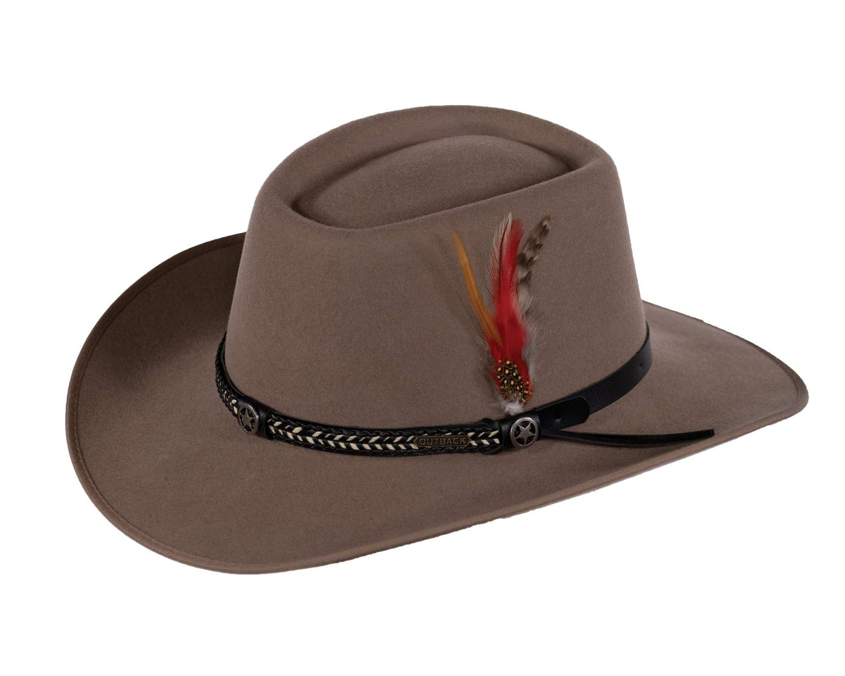 The Outback Cobra Wool Hat is a beige wide-brimmed wool hat, adorned with a black decorative band featuring intricate braiding and small silver skull accents. A cluster of colorful feathers—red, orange, and brown—is attached to the band for added Outback flair.