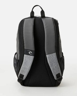 The Rip Curl Fader 28L Hydro Backpack boasts a sleek black and gray design, complete with padded shoulder straps and a small loop handle at the top. Its breathable airmesh back panel ensures optimal comfort, while side mesh pockets offer additional storage space. For added convenience, the backpack also features a dedicated padded laptop section.