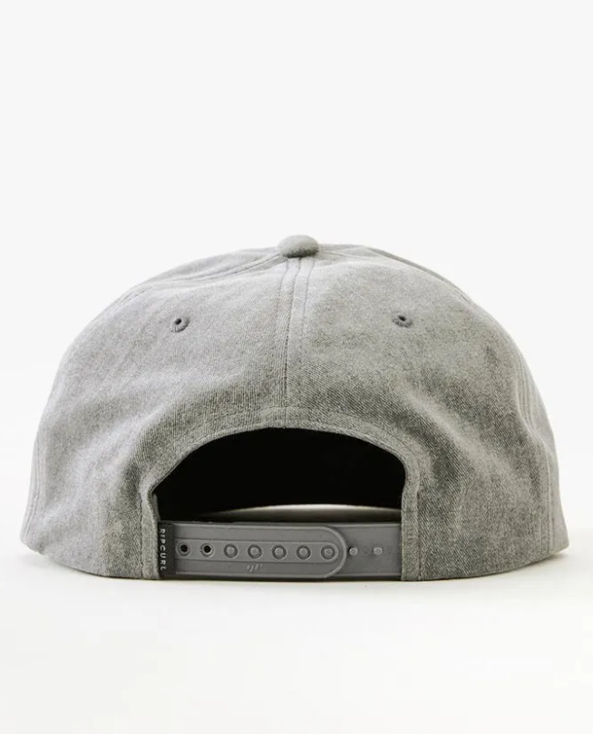 The image depicts the back of a gray Rip Curl Wetty Snap Back Cap, featuring a soft fabric with a top button and a plastic adjustable strap for sizing. The background is plain white.