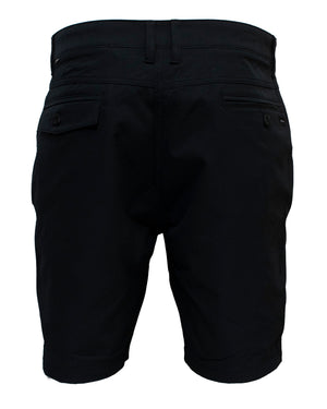 A pair of Rip Curl Boardwalk Oceanside Shorts viewed from the back, featuring buttoned pockets and belt loops. These stylish and comfortable black shorts are knee-length with a tailored look, designed for a comfortable fit. Made from 100% polyester, the material appears sturdy and suitable for casual or semi-formal wear.