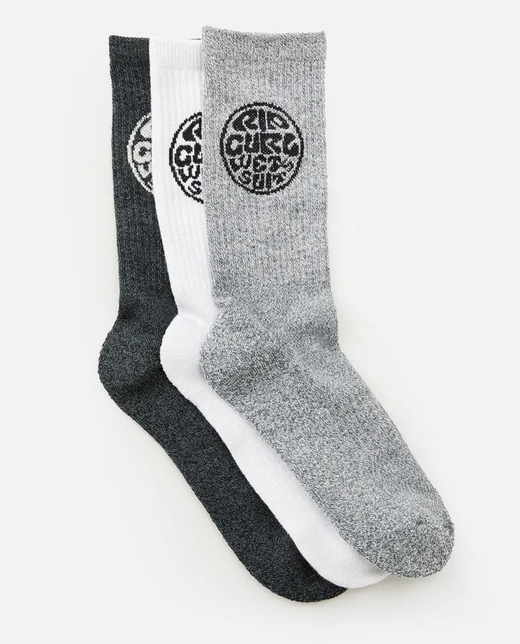 Three pairs of Rip Curl Wetty Crew Socks, overlapping and neatly arranged. Each sock features a circular black Rip Curl logo with stylized text at the top. The sock colors are dark gray (back), white (middle), and light gray (front), all displayed against a plain white background. Bonus: built-in arch support for added comfort!