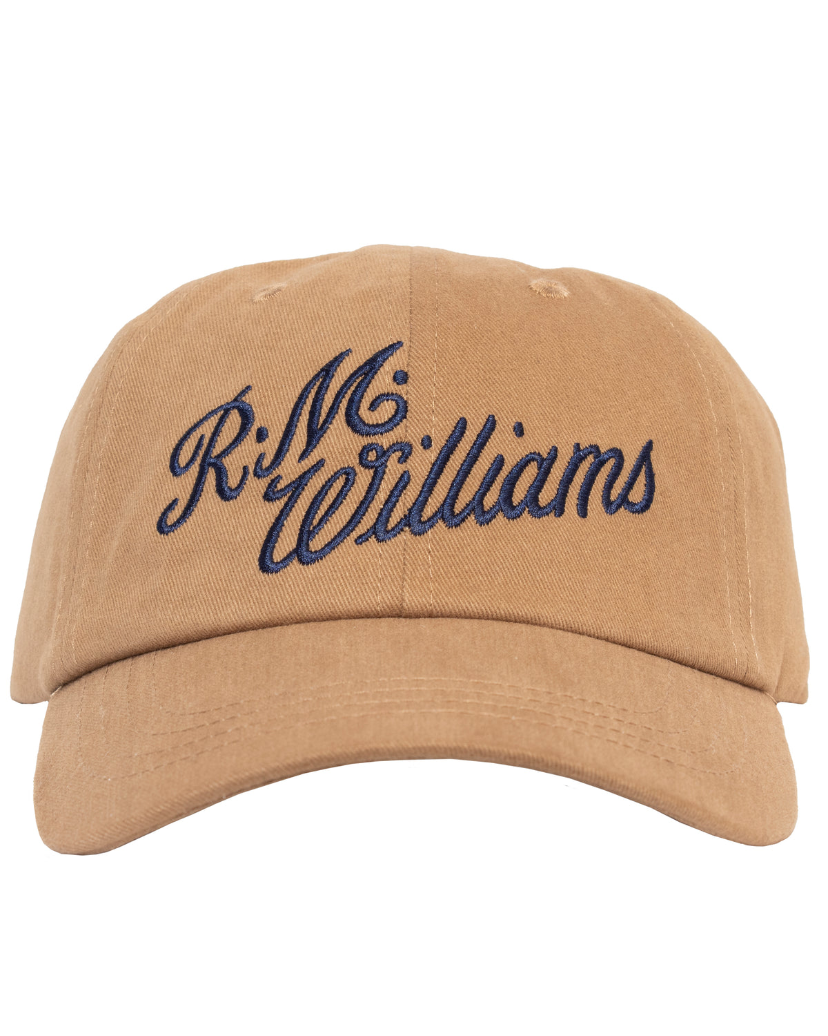The RM Williams Script Cap is a lightweight, breathable beige baseball cap featuring "R.M. Williams" embroidered in navy blue cursive text on the front. Made from 100% cotton, this clasp-back cap showcases a curved brim and visible stitching details.