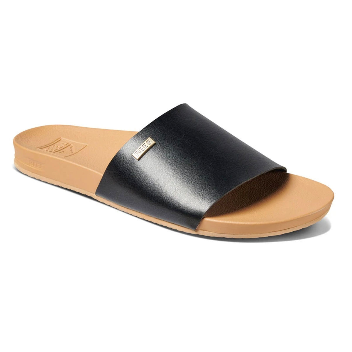 A single REEF Cushion Scout slide sandal in light brown, featuring a black vegan leather strap across the top. The contoured footbed is designed for comfort and includes a cushion bounce midsole, along with a small metallic logo tag on the side of the strap. The flat sole adds to its casual and minimalist design.