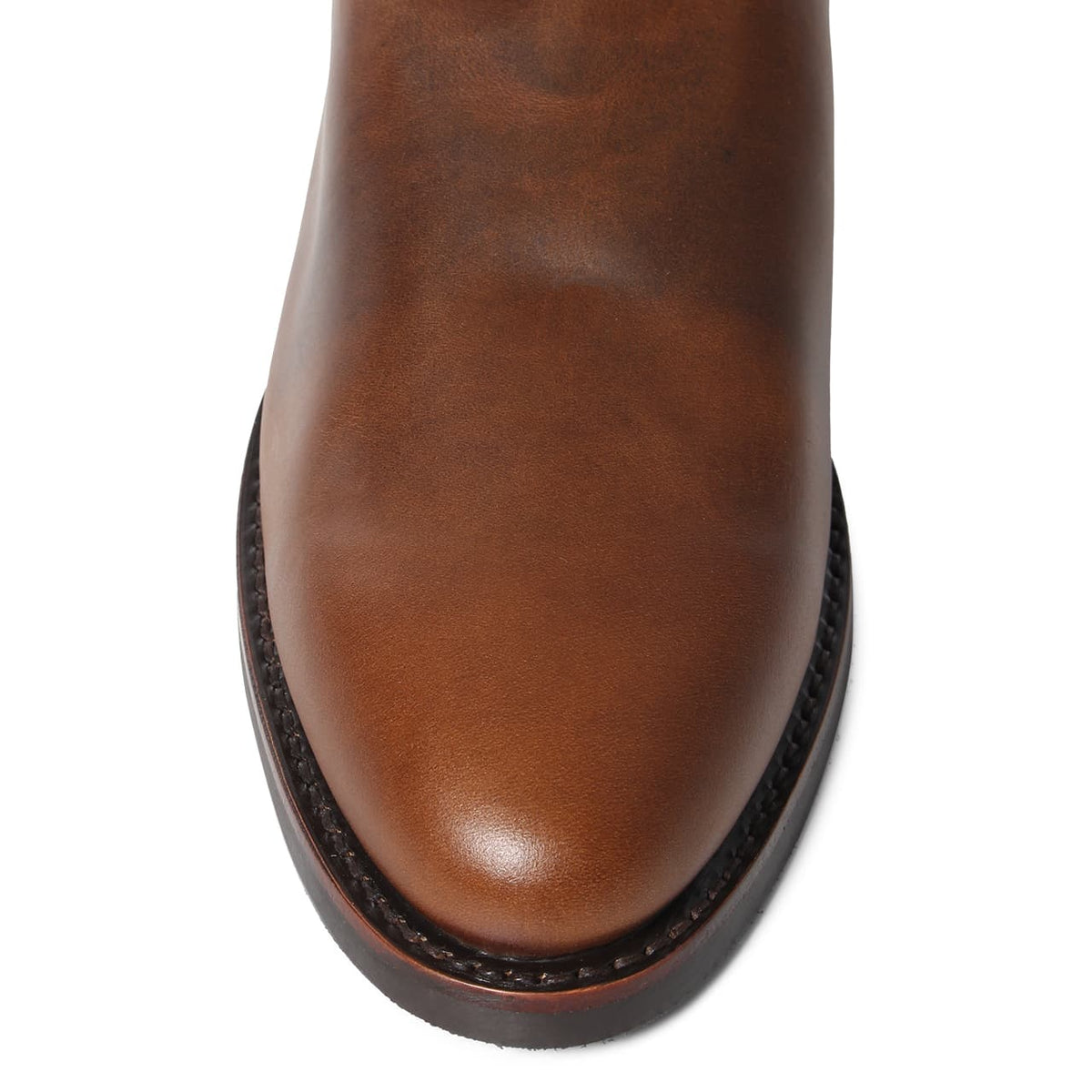 Top view of the toe section of a Ringers Western Kimberley Mens High Boot in brown genuine leather with a smooth, rounded finish. The boot features a sleek design with visible stitching along the sole's edge, showcasing craftsmanship and a polished surface.