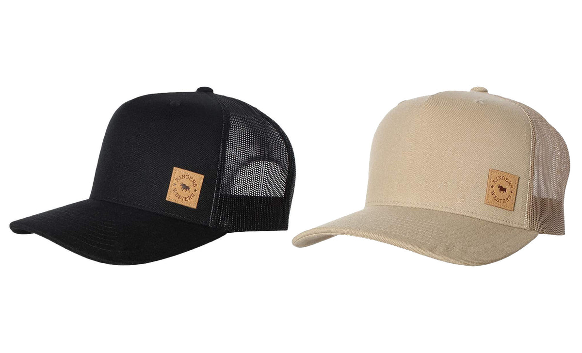 Two Patch Trucker Caps are displayed side by side. The left hat, a Ringers Western Patch Trucker Cap, is black with a mesh back and a small brown logo patch on the front. The right hat is beige with similar features, including an adjustable strap for comfort.