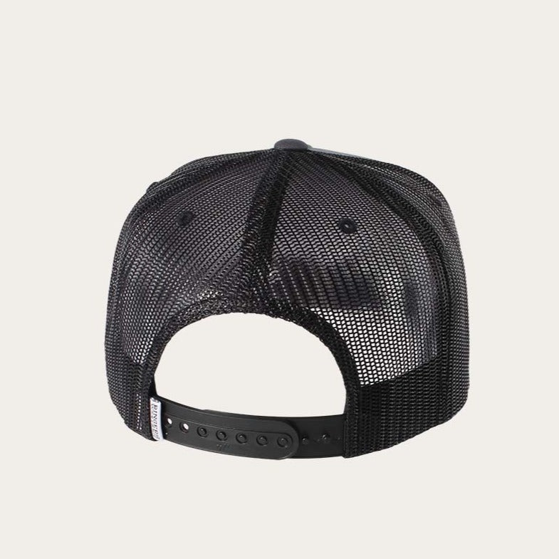 The image shows the back view of a black Ringers Western Garage Trucker hat. Featuring a snapback closure and an adjustable strap, this trucker cap offers size customization. The mesh back ensures excellent ventilation, while the overall background is a solid light color.