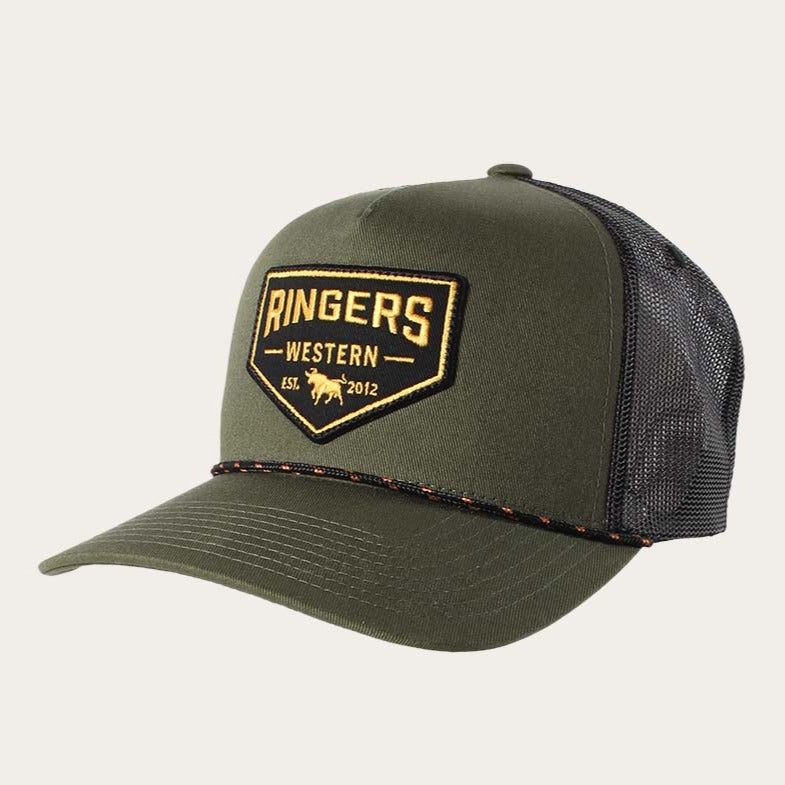 The Ringers Western Garage Trucker hat is green with a black mesh back, showcasing an embroidered patch on the front that says "Ringers Western, Est. 2012" along with an image of a bull. It features a rope detail above the brim and has an adjustable strap for a comfortable fit.