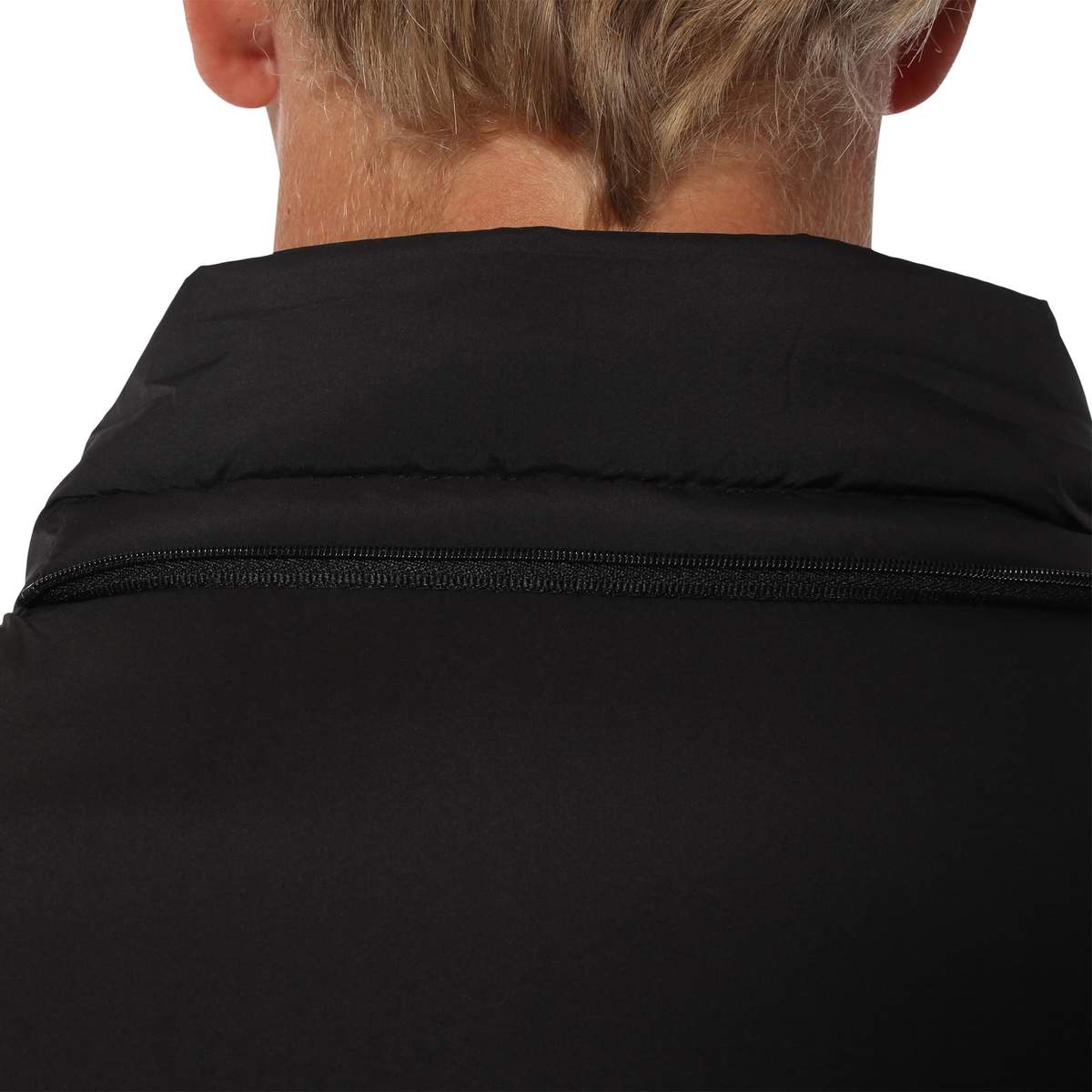 Close-up of a person's neck and shoulders from behind, wearing the Ringers Western Bairnsdale Puffer Jacket in black, featuring a high collar and visible zipper. The detachable hood is tucked neatly inside, with the person's blonde hair partially visible above the collar.