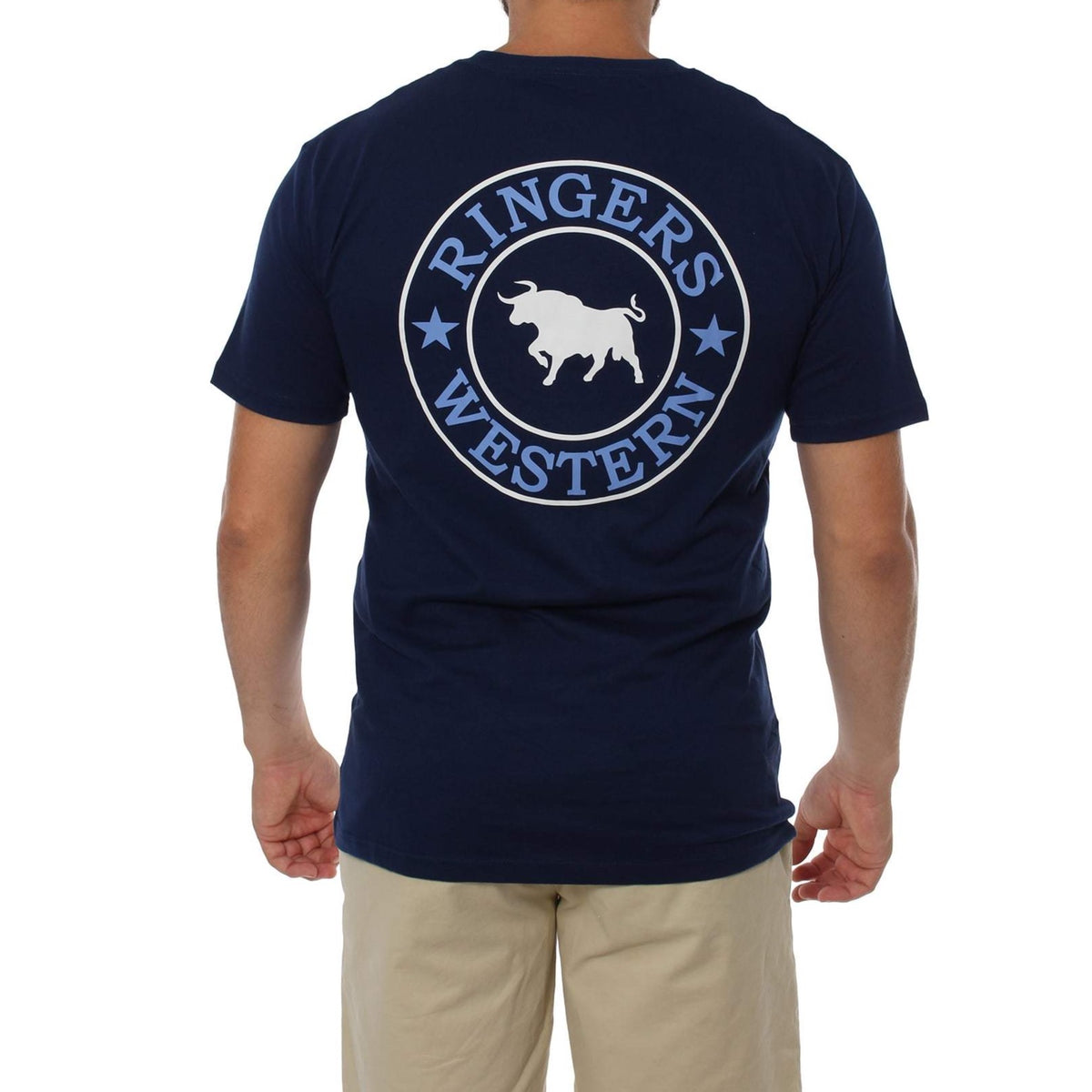 A person wearing the Ringers Western Signature Bull Classic T-Shirt in a comfortable navy blue crew neck style, featuring a circular logo on the back that reads "Ringers Western" around an image of a bull, with two stars on each side. The person is also wearing beige pants.