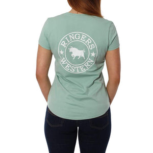 Woman faces away in a light green Ringers Western Signature Bull Relaxed V-Neck T-Shirt, made of 100% cotton, featuring a white "RINGERS WESTERN" and bull logo on the back, paired with dark jeans against a plain white background.
