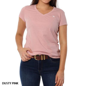 A woman wears the Ringers Western Signature Bull Relaxed V-Neck T-Shirt in dusty pink, made from 100% cotton with short sleeves and a small white logo on the left chest, paired with dark blue jeans and a brown belt against a plain white background.