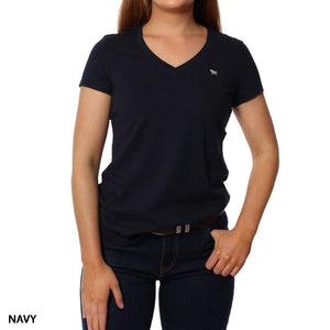 Woman wearing a plain navy Ringers Western Signature Bull Relaxed V-Neck T-Shirt and dark jeans, standing against a white background. The 100% cotton tee features a small embroidered logo on the left chest. "NAVY" is shown in the bottom left corner.