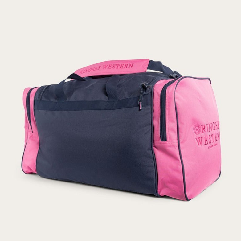 The Ringers Western Rider Sports Bag showcases a pink and dark blue color scheme. It is designed with two handles, two side pockets, and a zippered main compartment, all of which prominently feature the "Ringers Western" branding on the handles and one side pocket.